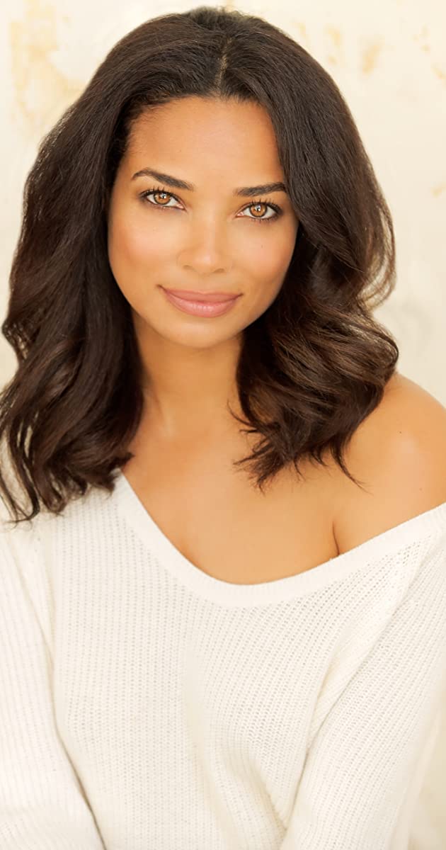 Rochelle Aytes posing for a photo wearing white off shoulder tshirt